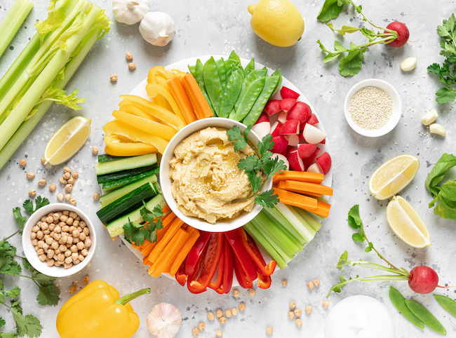 Hummus with fresh vegetables, healthy vegetarian food concept, top view